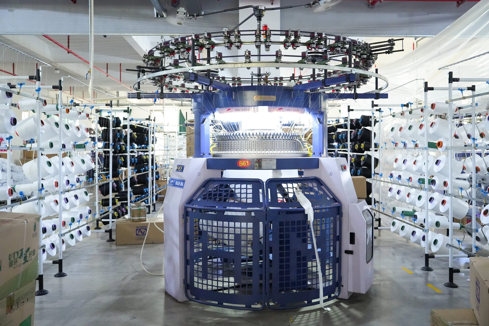 Advanced textile knitting machines at Huada Creation factory floor showing precision manufacturing equipment